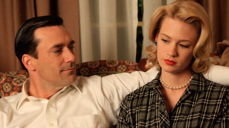 Jon Hamm and January Jones sitting on couch