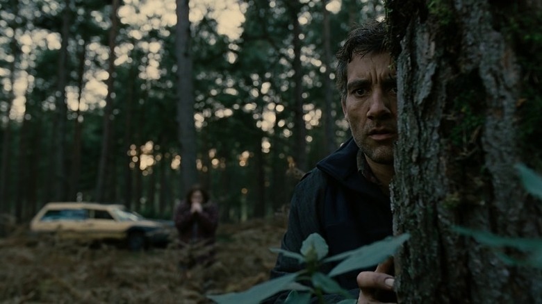 Theo Faron hiding behind tree in Children of Men