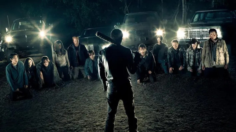 The Walking Dead Negan approaches the kneeling survivors