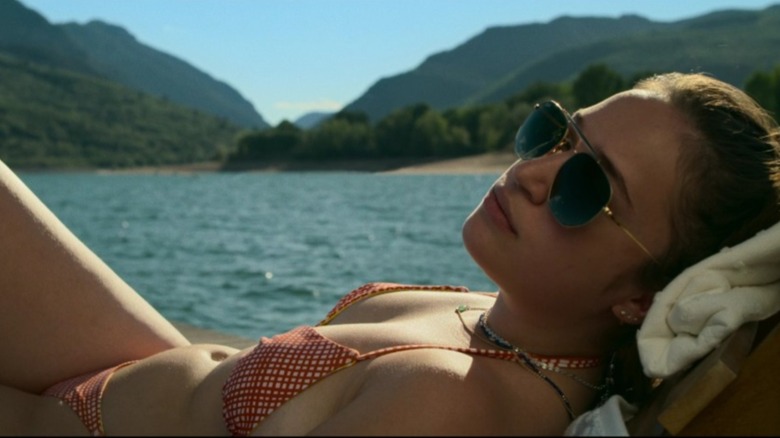 Gideon Adlon reclining by lake in Sick