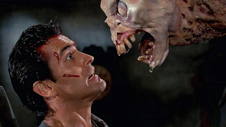 Ash Williams confronted by a demon in Evil Dead II