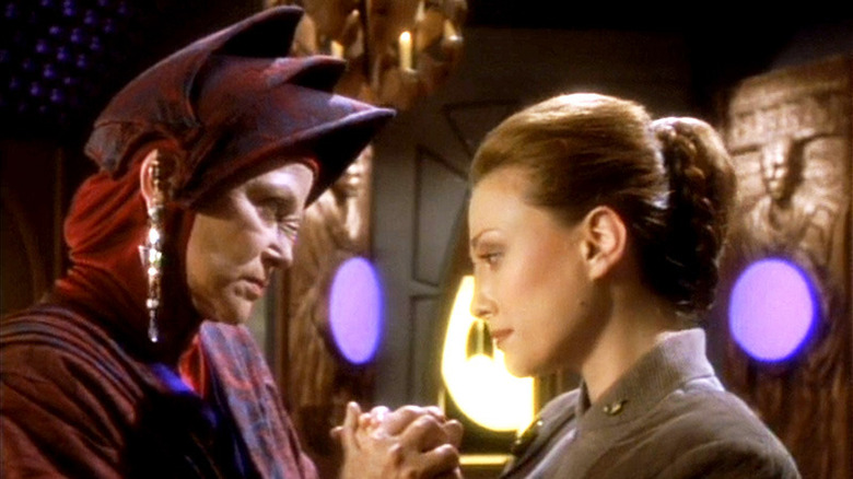 Kai Winn and Kira Nerys clasp hands