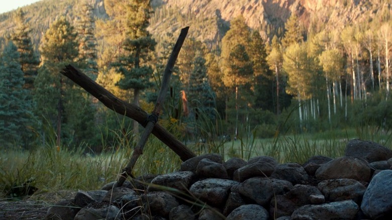 Sticks forming X on Logan's grave