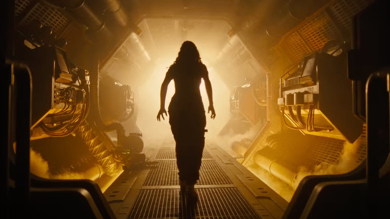 A woman walks down a corridor in Alien: Romulus