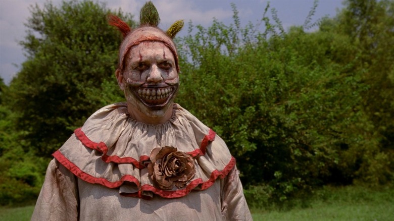 Twisty the Clown by the trees in American Horror Story